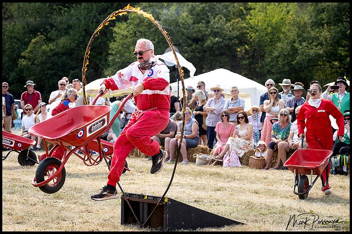 Performer jumping through flaming hoop