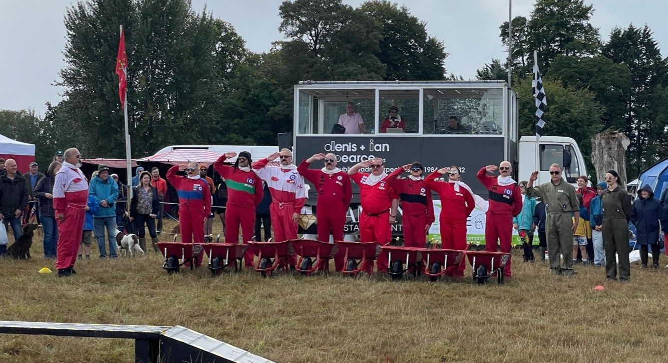 Team saluting in formation with spectators