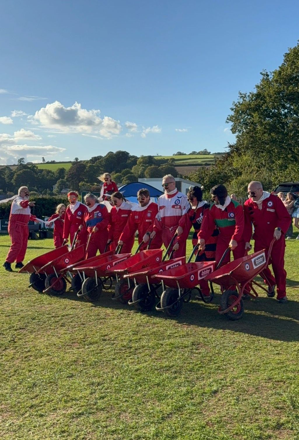 Team marching in formation with wheelbarrows